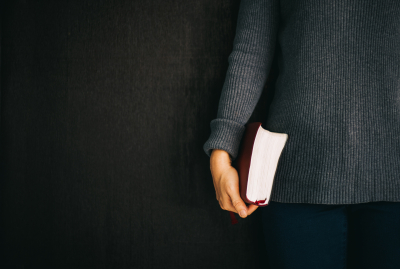 woman holding the bible in right hand.